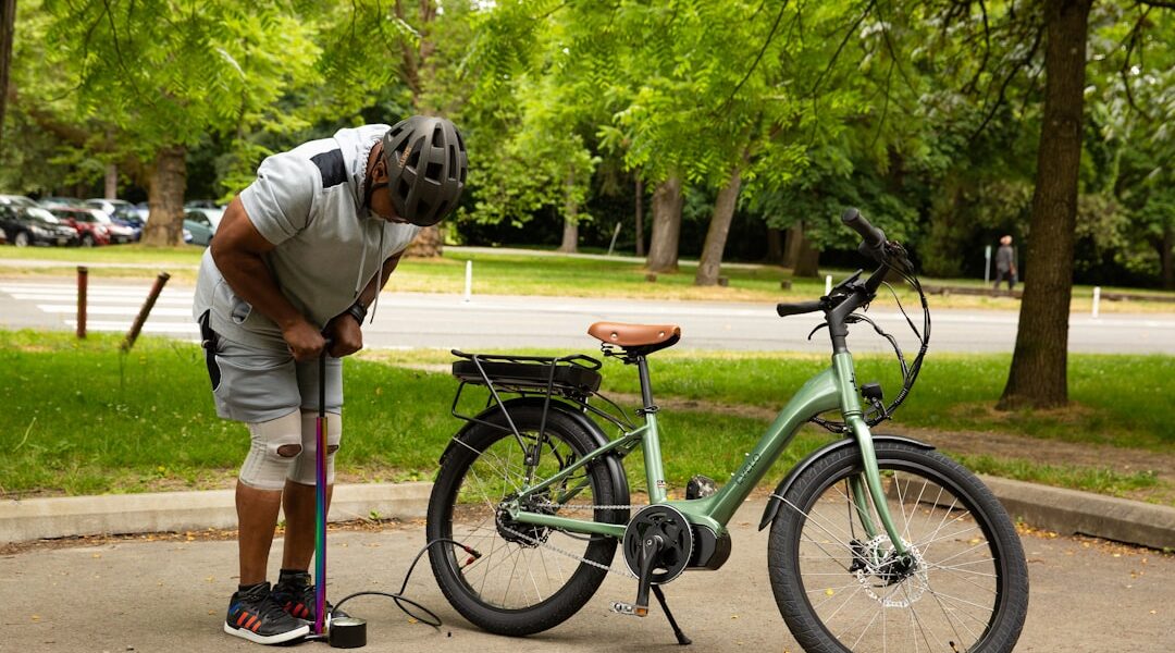 cyclist checking tire pressure gauge road bike