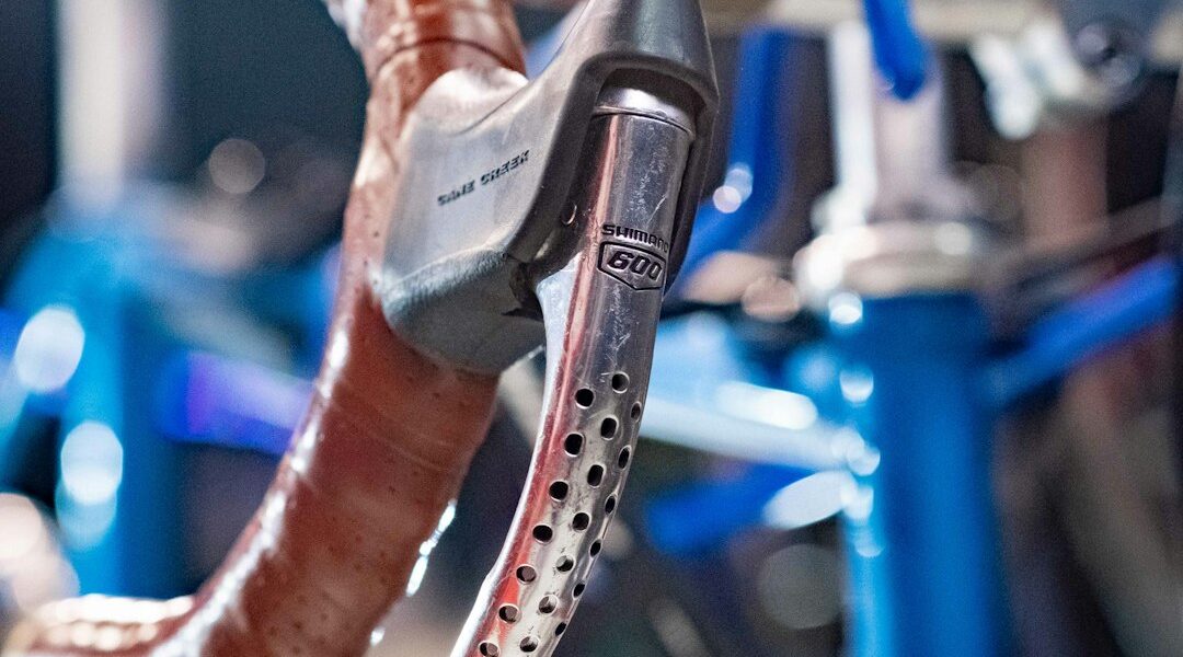cyclist adjusting bike saddle height hex wrench